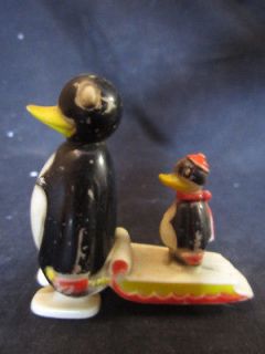 Vintage hard plastic moving toy penguin with sled & baby Hong Kong