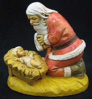   Kneeling Santa with Baby Jesus in the Manger Christmas Figurine 65015