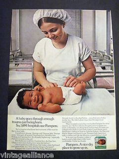   Pampers Newborn Baby in Diapers with Nurse in Nursery 70s Print Ad