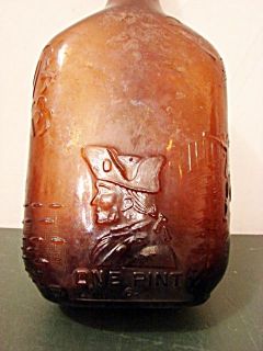 VINTAGE EMPTY BROWN PINT WHISKEY FLASK  BOTTLE WITH COLONIAL FIGURE 