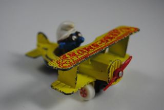1982 ERTL SMURF die cast tri airplane toy.