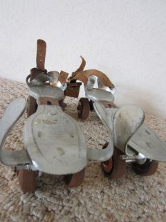 pair of old child s flying ace steel roller skates