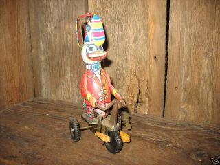 vintage tin wind up toy cool duck on trike spinning