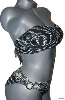   exotic flair to this twisted bandeau bikini top by Carmen Marc Valvo