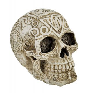   human skull figure statue is covered in celtic knotwork patterns