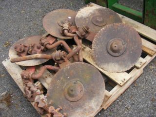 Massey Ferguson moldboard plow coulters with mounting clamps.