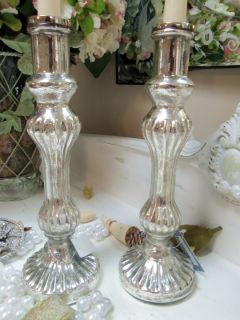 featured is a set of ribbed design mercury glass candlesticks these