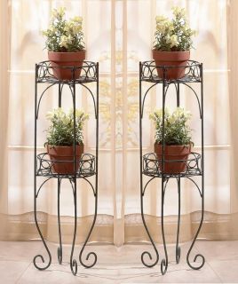  scrolls in a verdigris style finish comprise thess two shelf plant